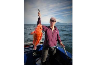 man holds a large red fish