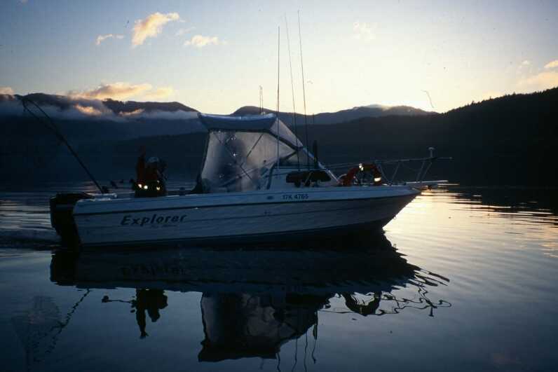 motorized boat heading out during sunset