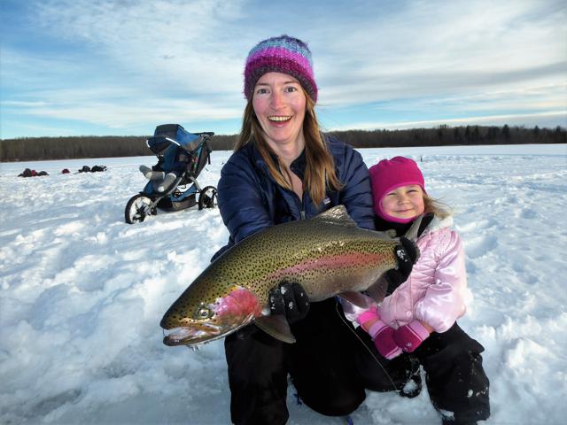 Melanie grabs on and pulls a mega trout out of the hole.  Cedar’s so happy!