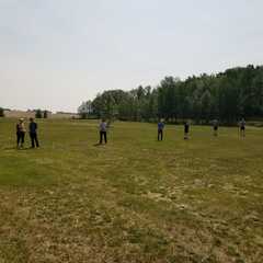 grass field with people standing around